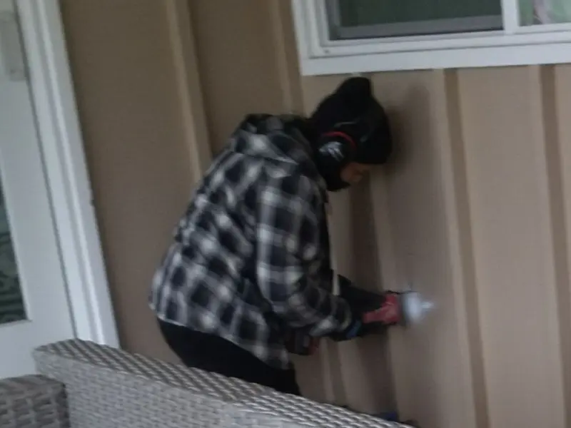 Professional electrician installing an exterior outlet in Cheboygan